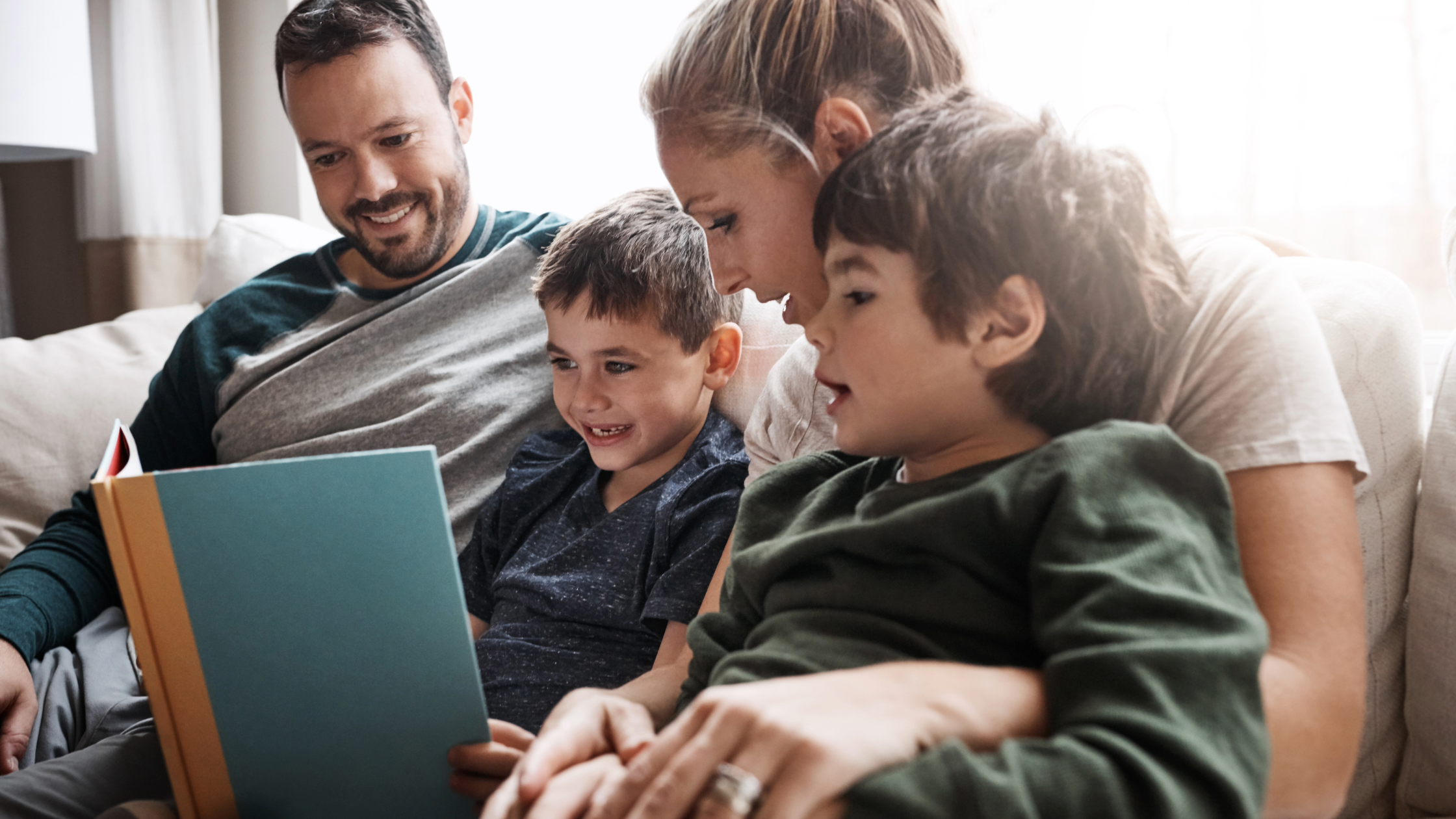 Family reading books together with young children