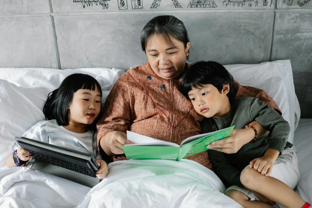 Family reading together in bed