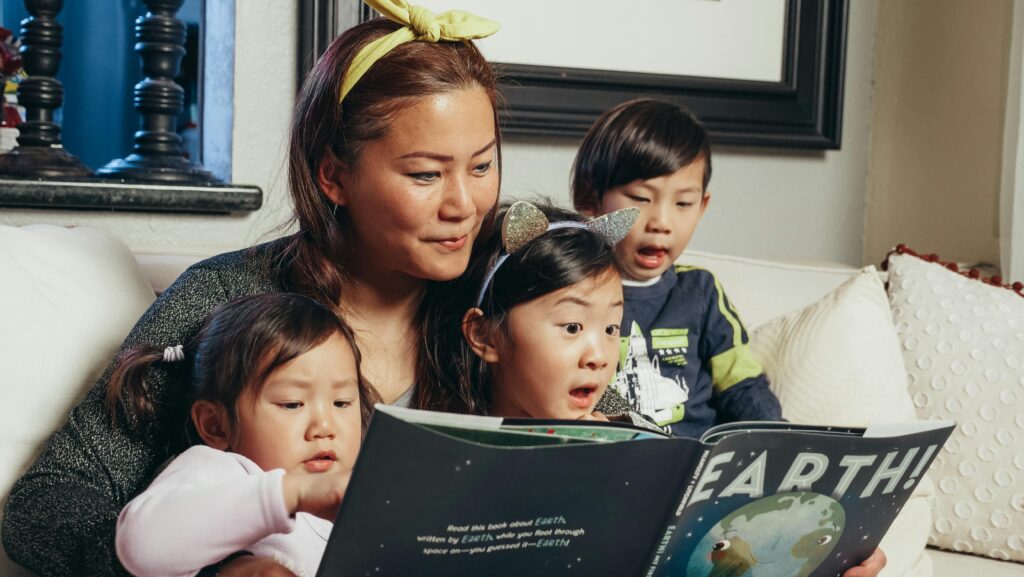 mom reading to her kids of all ages at storytime