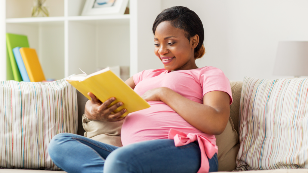 Pregnant woman reading to her baby