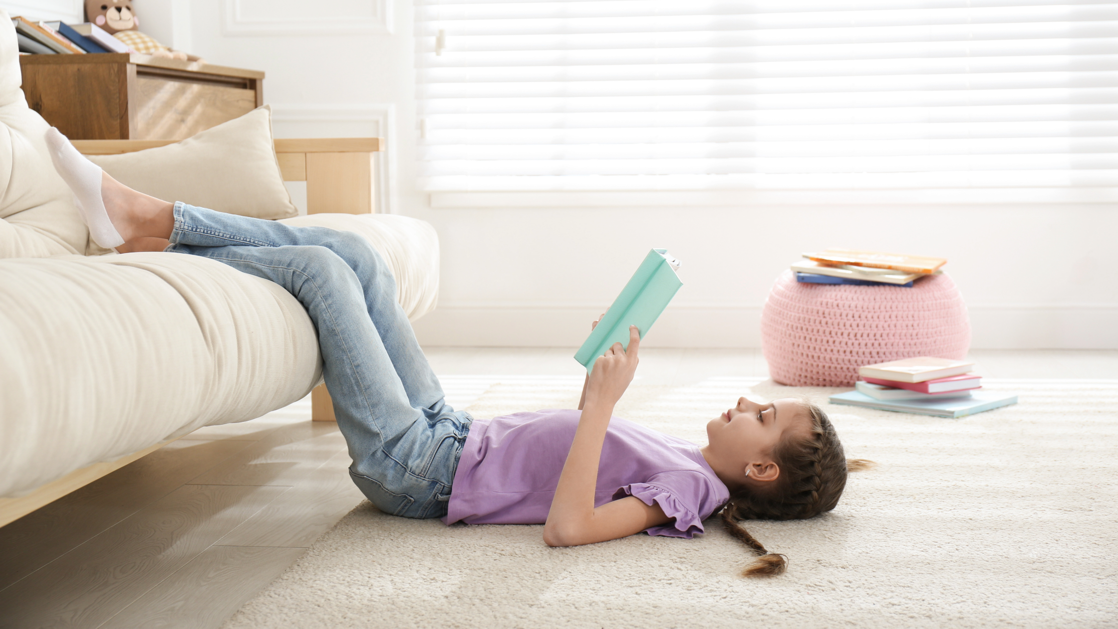 Preteen Reading Chapter Book on Floor