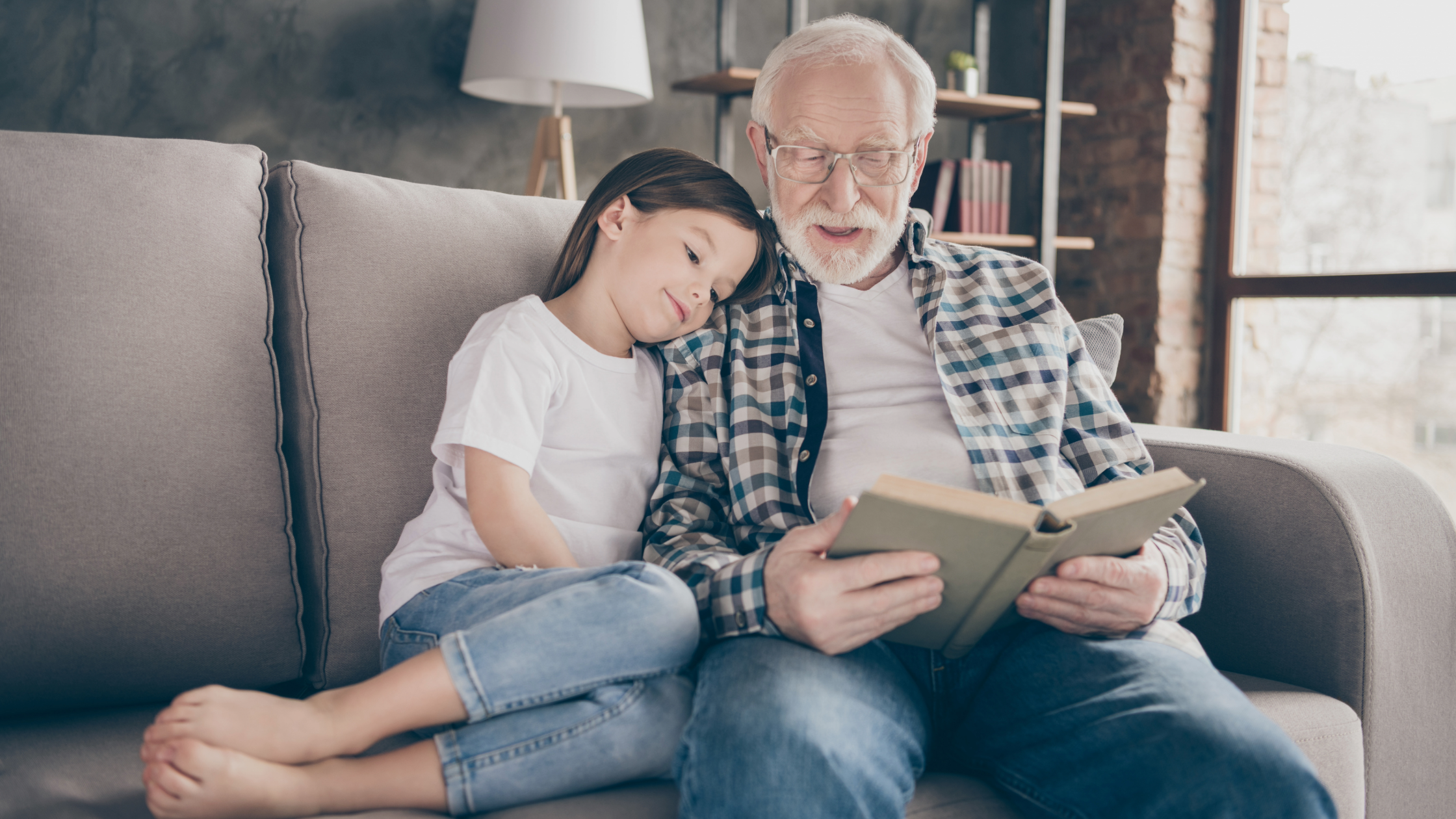 Grandparent reading book to preteen child