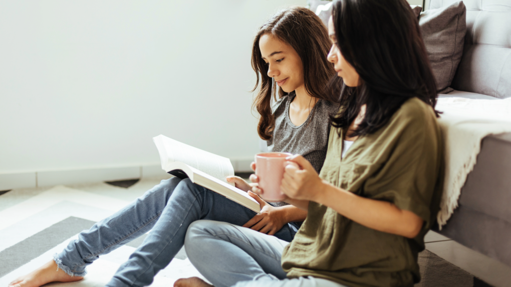 Teen girl and mother reading Bible together