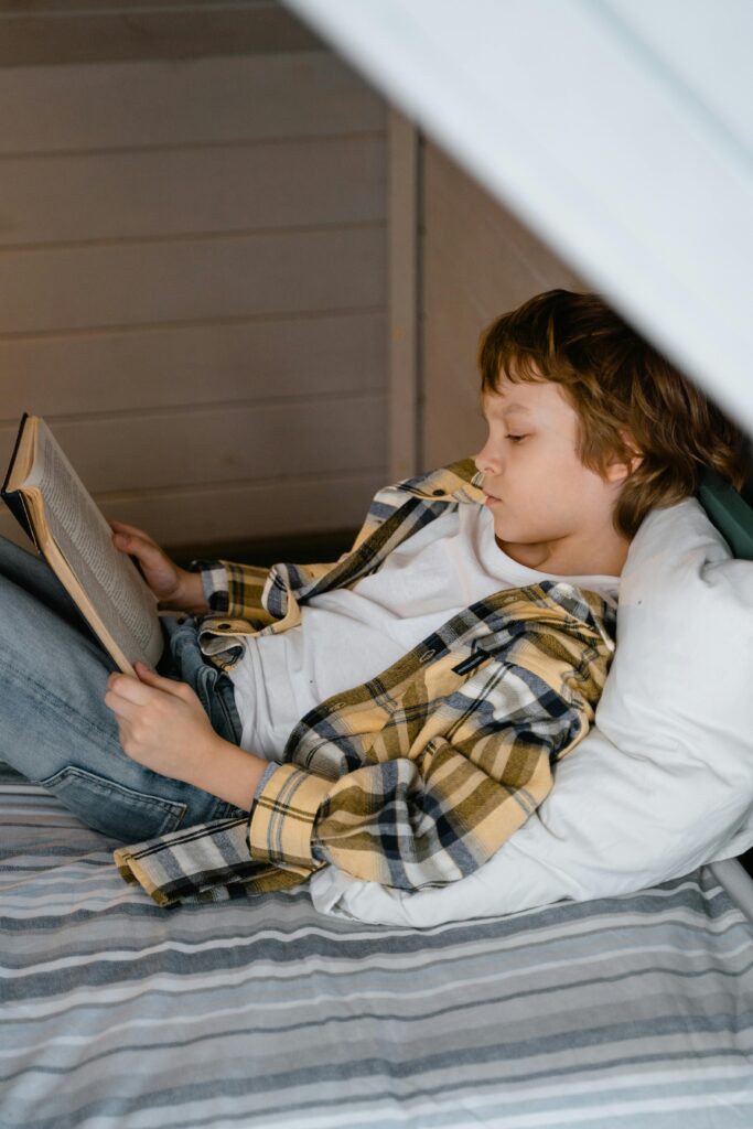 tween boy reading a book