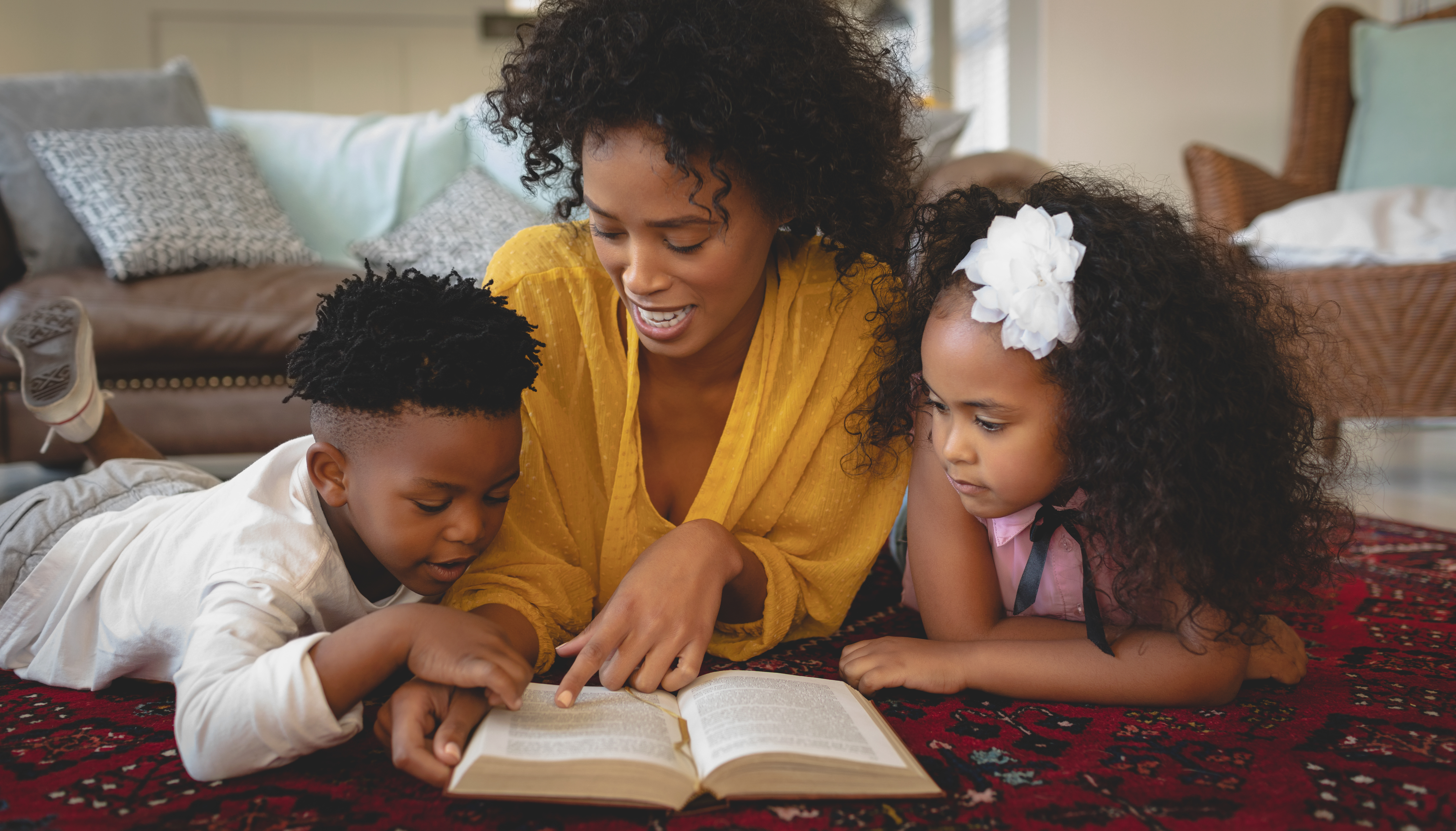 Grandparent reading book to preteen child