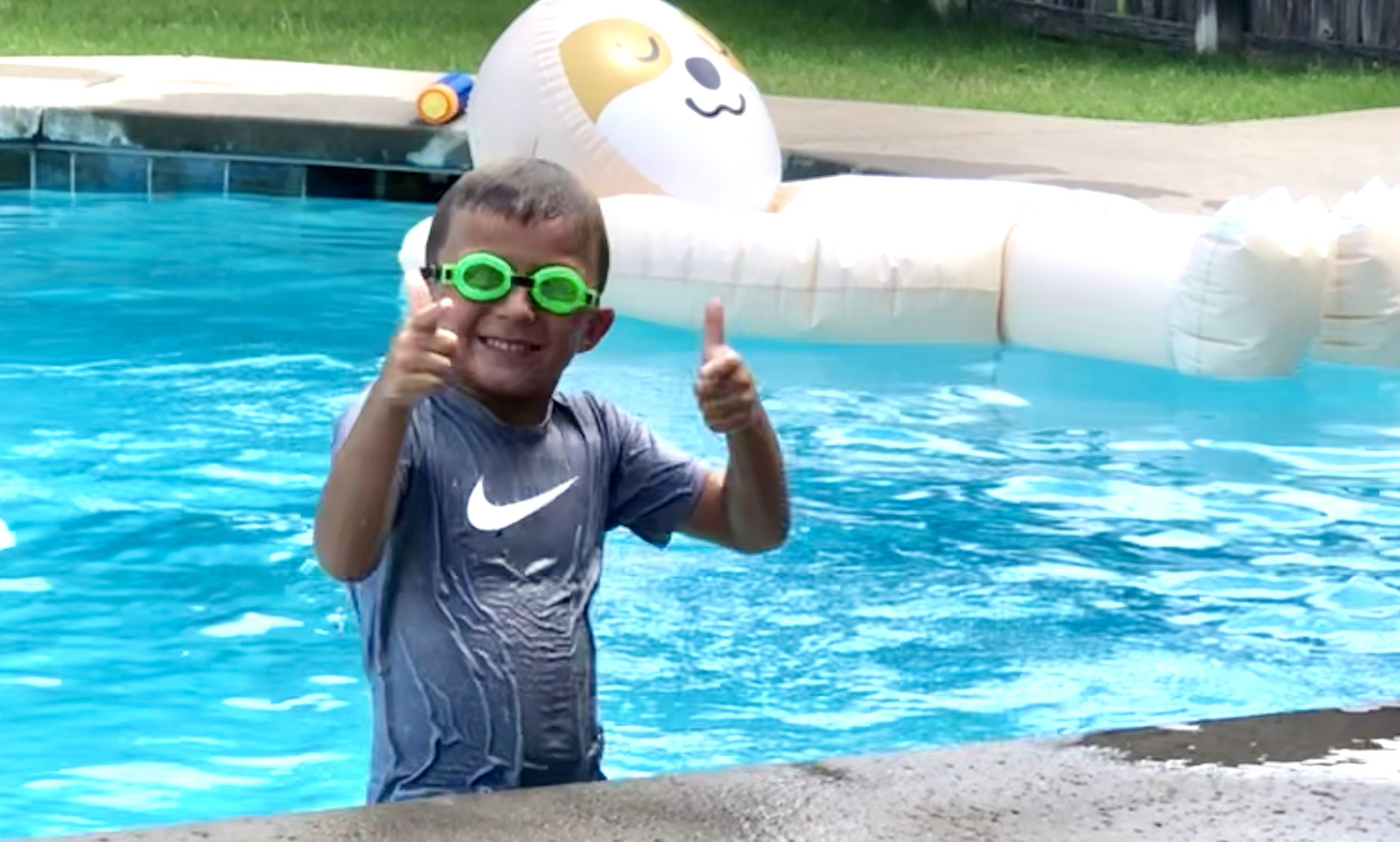 boy swimming in a pool in summer